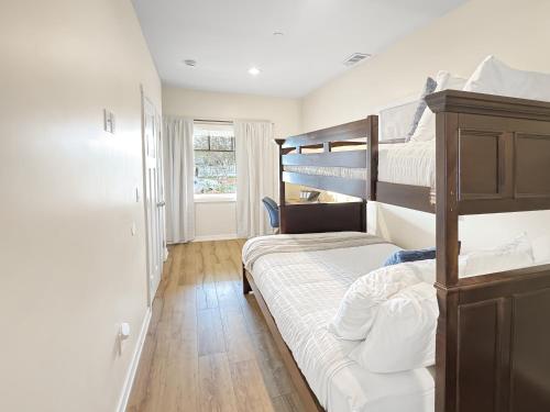 a bedroom with two bunk beds and a window at F-60 Disney Dream Craftsman in Anaheim