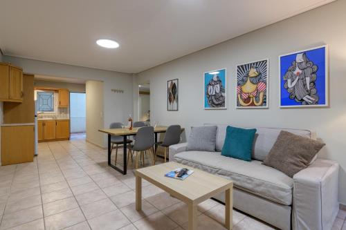 a living room with a couch and a table at Two steps from Acropolis in Athens