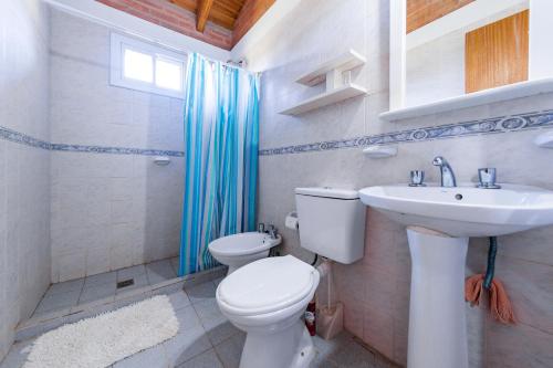 a bathroom with a toilet and a sink at El Encuentro Casa de Campo in Río Cuarto