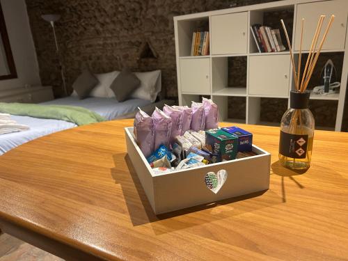 a table with a box of toothpaste and a bottle on it at Teatro Vecchio 11 in Bassano del Grappa