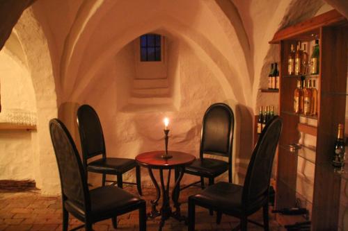 a room with chairs and a table with a candle on it at Kokkedal Slotshotel in Brovst