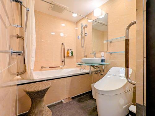 a bathroom with a toilet and a sink and a shower at APA Hotel Morioka Ekimae in Morioka