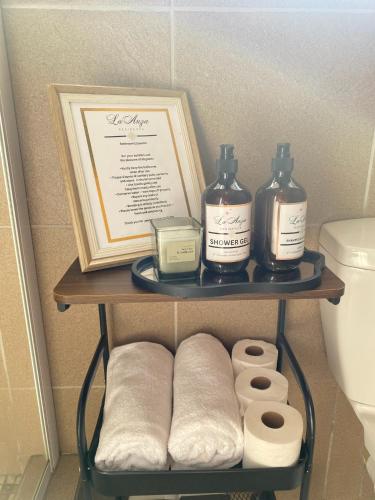a shelf with toiletries and a picture in a bathroom at Andisa Airport Escape in Kempton Park