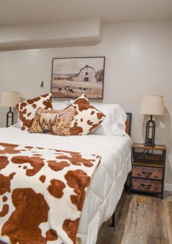 a bed with brown and white sheets and pillows at Basement apartment in Twin Falls