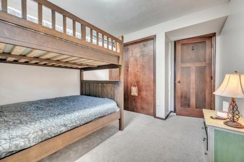 a bedroom with a bunk bed and a desk with a lamp at Bridges Bay Vacation Cabin 185 in Arnolds Park