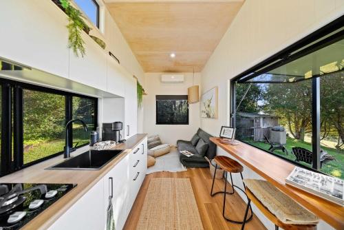 a kitchen and living room of a tiny house at Lily Pad Tiny Home in Maleny