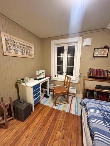 a bedroom with a desk and a bed and a window at Old farm house & sauna in Stunes