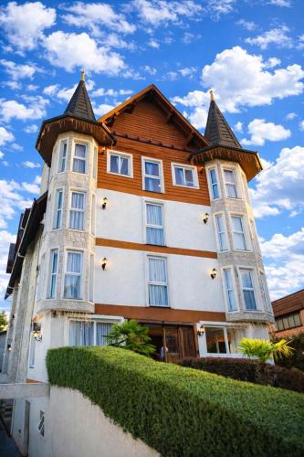 a large building with a pointed roof at Hotel Locanda Casa D'Oro in Gramado