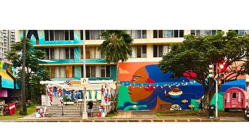 a building with a mural on the side of it at Central YMCA Residences in Honolulu