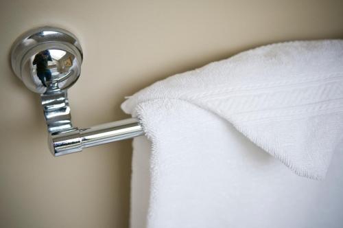 a hotel room door knob with a white towel at O Canada House Bed & Breakfast in Vancouver