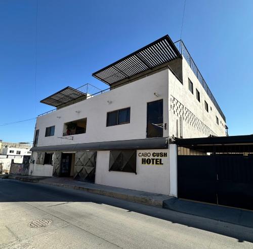 a white building with a sign that reads closed often hotel at The Cabo Cush Hotel in Cabo San Lucas