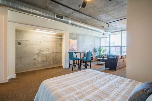 a bedroom with a bed and a table and chairs at Skyline Loft Studio w City Views in Phoenix