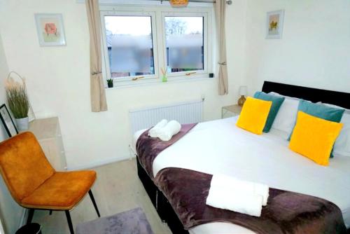 a bedroom with a bed and a chair at Peckham City Vibes 2BR with Wi-fi and Balcony in London