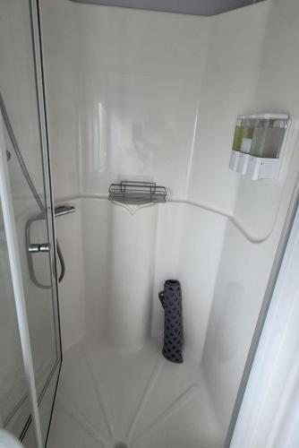 a bathroom with a shower with a black controller in it at HolidayLet 24 Bude Newperran Holiday Park in Cubert