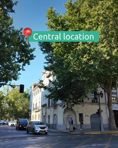 a sign that reads central location in front of a building at Hostel Boutique Merced 88 in Santiago