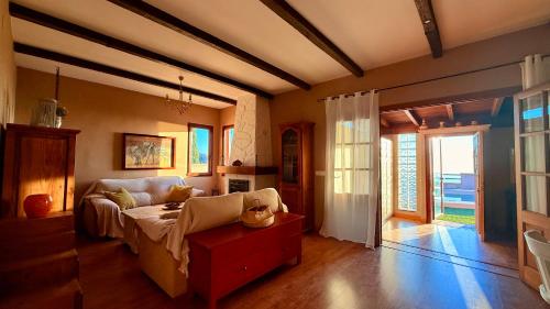 a living room with a couch and a table at LA CASA ROJA Casa privada con piscina y vistas Zona Torrox in Torrox