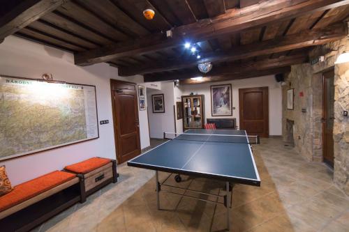 a ping pong table in the middle of a room at Penzión Banská Klopačka in Hnilčík