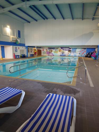 a large swimming pool with a large swimming pool at Lakeside Caravan White Acres Holiday Park Newquay Sleeps 6 in Saint Enoder