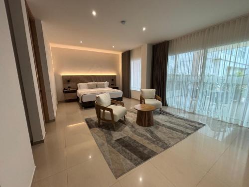 a hotel room with a bed and a table and chairs at Casa Aurora Luxury Hotel in Cali