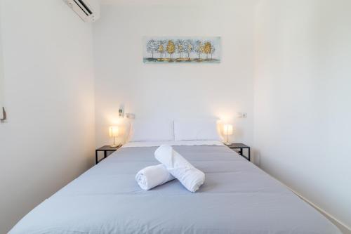 a bedroom with a white bed with two pillows at AYZ Joaquín Pol - Auto check-in property in Madrid
