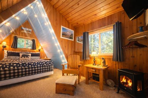 a bedroom with a bed and a fireplace at Serenity A Frame in Ashford