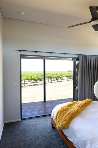 a bedroom with a bed and a sliding glass door at Buller Wines in Rutherglen
