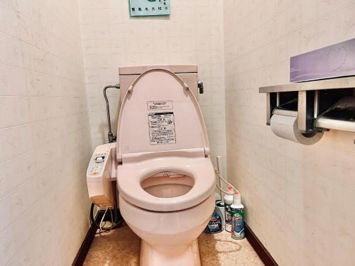a bathroom with a toilet with the lid up at 神庭武道館 in Chichibu