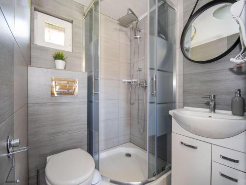a bathroom with a shower and a toilet and a sink at Comfortable holiday homes, jacuzzi, summer pool in Łacko