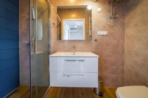 a bathroom with a sink and a shower at Holiday homes with pool, close to the beach in Rewal