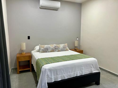 a bedroom with a bed and a air conditioner at Departamento la estación Tequila in Tequila
