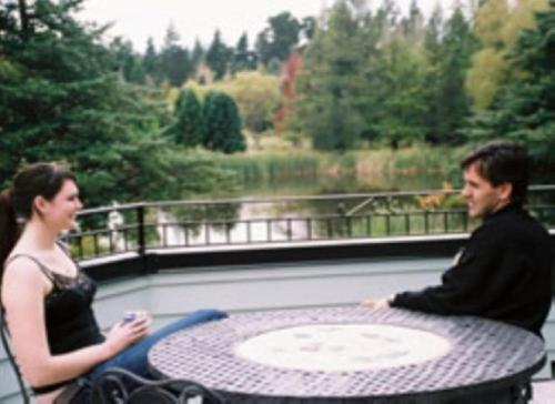 a man and a woman sitting at a table at Fontainebleau Luxury B&B in Hanmer Springs