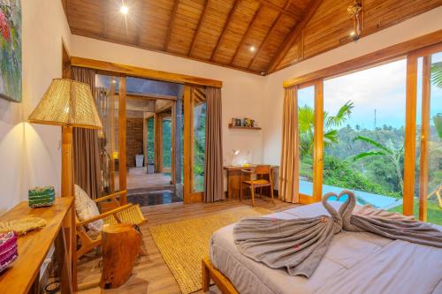 a bedroom with a bed and a desk and a table at Balian Hideaway - MON Villa in Balian