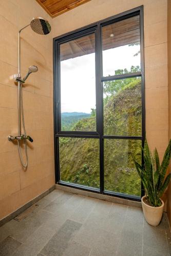 a bathroom with a shower and a large window at Balian Hideaway - MON Villa in Balian