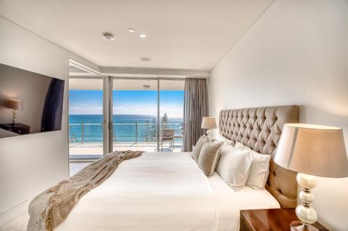 a bedroom with a large bed with a view of the ocean at Sea Pearl A1 Beach Resort in Mooloolaba