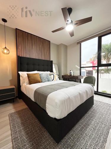a bedroom with a large bed with a ceiling fan at Private Suite with bathroom and top amenities in La Cañada