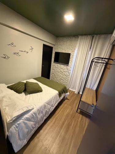 a bedroom with a bed and a flat screen tv at Apartamento COMPLETO- Próximo ao shopping JL in Cascavel