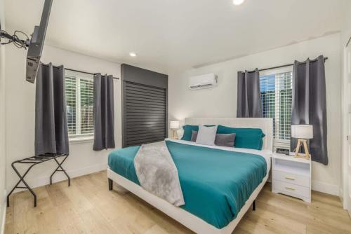 a bedroom with a large bed and windows at The Flats- Executive Suite-Downtown CDA in Coeur d'Alene