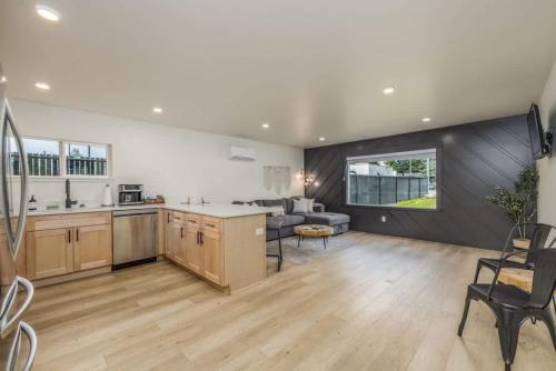 a kitchen and living room with a couch and a table at The Flats- Executive Suite-Downtown CDA in Coeur d'Alene
