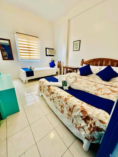 a hotel room with two beds and a couch at shanedel's inn & café in Basco