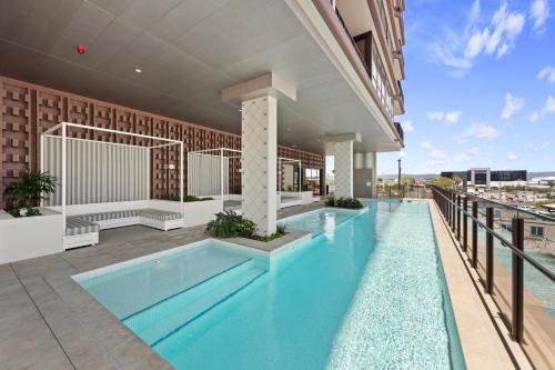 a swimming pool on top of a building at Yves Mermaid Beach Apartments by CLLIX in Gold Coast