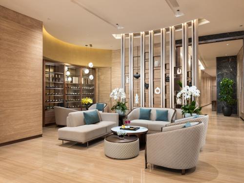 a lobby with couches and chairs and a table at Classyc Hotel Hang Thung in Hanoi