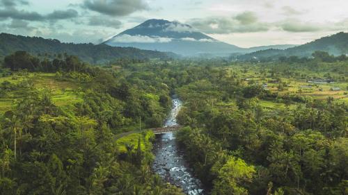 an aerial view of a river and a mountain at Darmada Eco Resort in Sidemen
