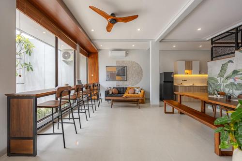 a living room with a table and chairs and a ceiling fan at Cove Ruma Coliving in Denpasar