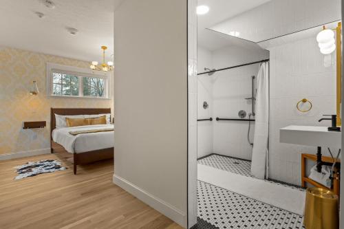 a bedroom with a bed and a bathroom with a sink at Assemble Boise in Boise