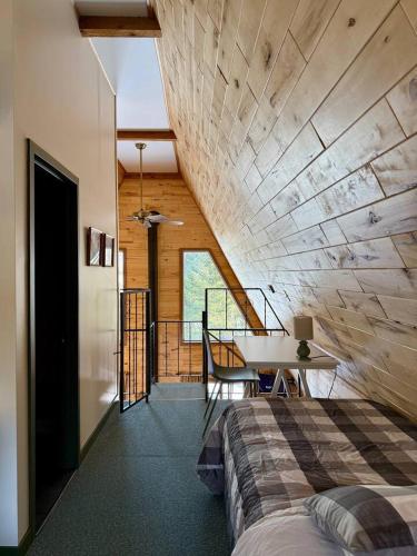 a bedroom with a bed and a desk in a room at Cedar Cove Cabin 5 in Butternut