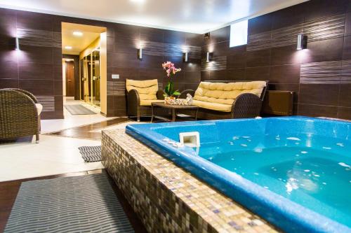 a jacuzzi tub in a living room at Bellevue Park Hotel Riga with FREE Parking in Rīga