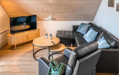 a living room with a couch and a tv at Cozy Home In Gråsten With Kitchen in Gråsten