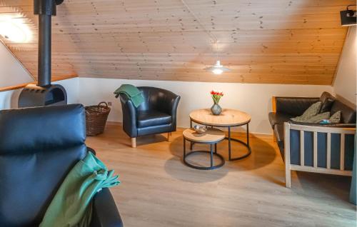 a living room with two chairs and a table at Cozy Home In Gråsten With Kitchen in Gråsten