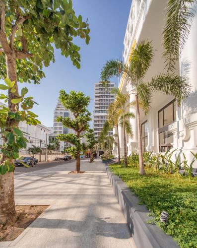 a street with palm trees and buildings at Sea Soul Hotel in Nha Trang
