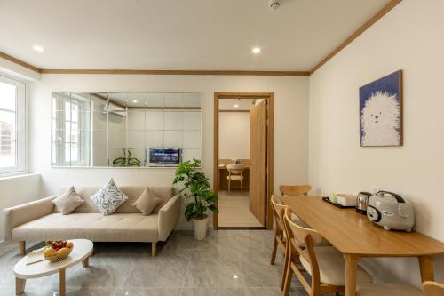 a living room with a couch and a table at KOA Apart Hotel Phu Quoc in Phú Quốc
